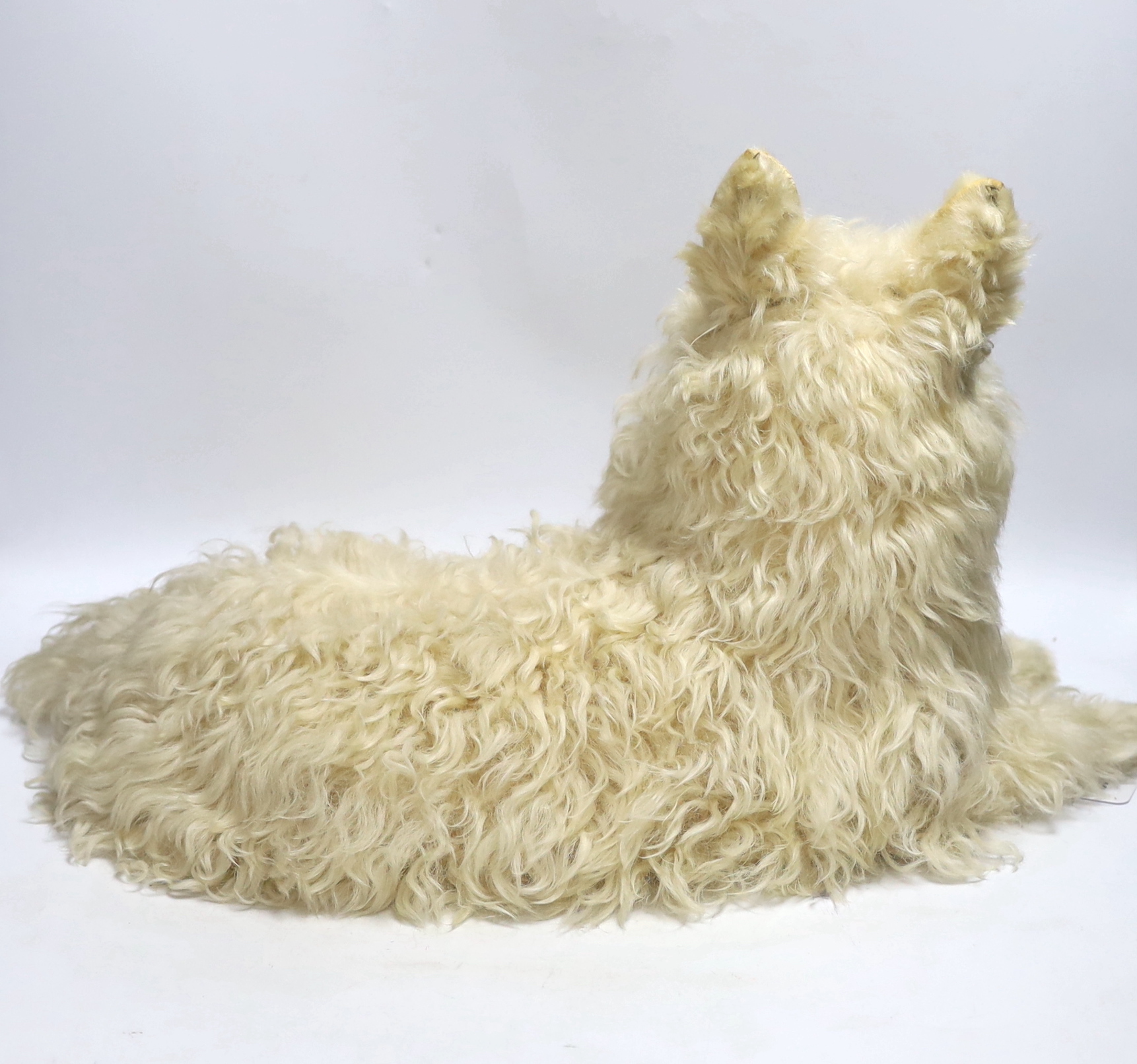A felt and fur seated dog nightdress case, with articulated head and tail, 50cm long